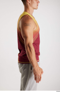 Darren  1 arm dressed flexing red-yellow tank top side…